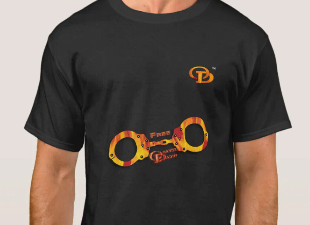 black t shirt with  free Orange Daddy and fire handcuffs (fire 'cuffs) and the Orange Daddy logo (OD) on the front.  there is an embedded hyperlink to my Zazzle store to this shirt, which comes in many colors